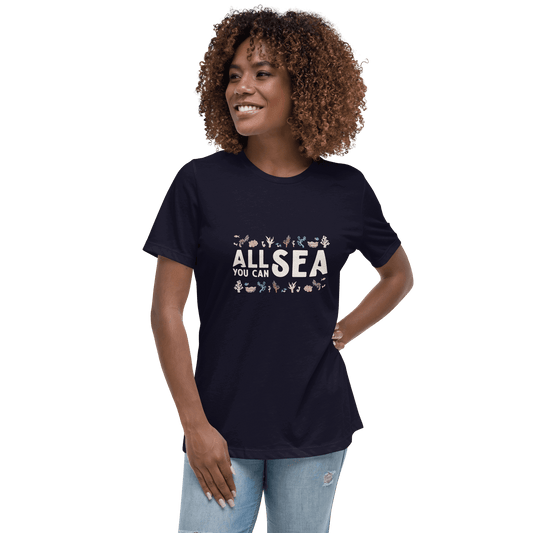 Woman wearing a navy blue t-shirt with 'All Sea You Can' text and graphics